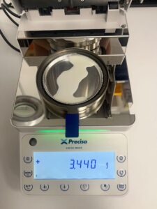 Picture of open moisture analyzer with milk poured in without filter paper